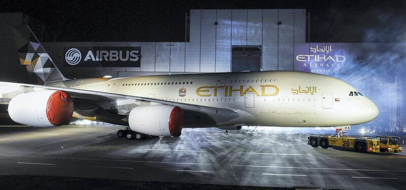 An Airbus A380-800 rolls out of a paint hangar during a branding ceremony of Etihad Airways, the national airline of the United Arab Emirates (UAE), at the German headquarters of aircraft company Airbus, in Hamburg-Finkenwerder September 25, 2014.  Abu Dhabi's state-owned Etihad Airways showed off its first A380 super jumbo and unveiled its new branding on Thursday as it seeks to up the battle in the luxury stakes and continue its rapid growth.  REUTERS/Fabian Bimmer (GERMANY - Tags: TRANSPORT BUSINESS) - GM1EA9Q0IQU01