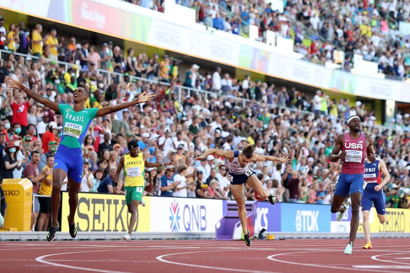 Alison dos Santos and Rai Benjamin cross the finish line in the men's 400m hurdles final. Getty
