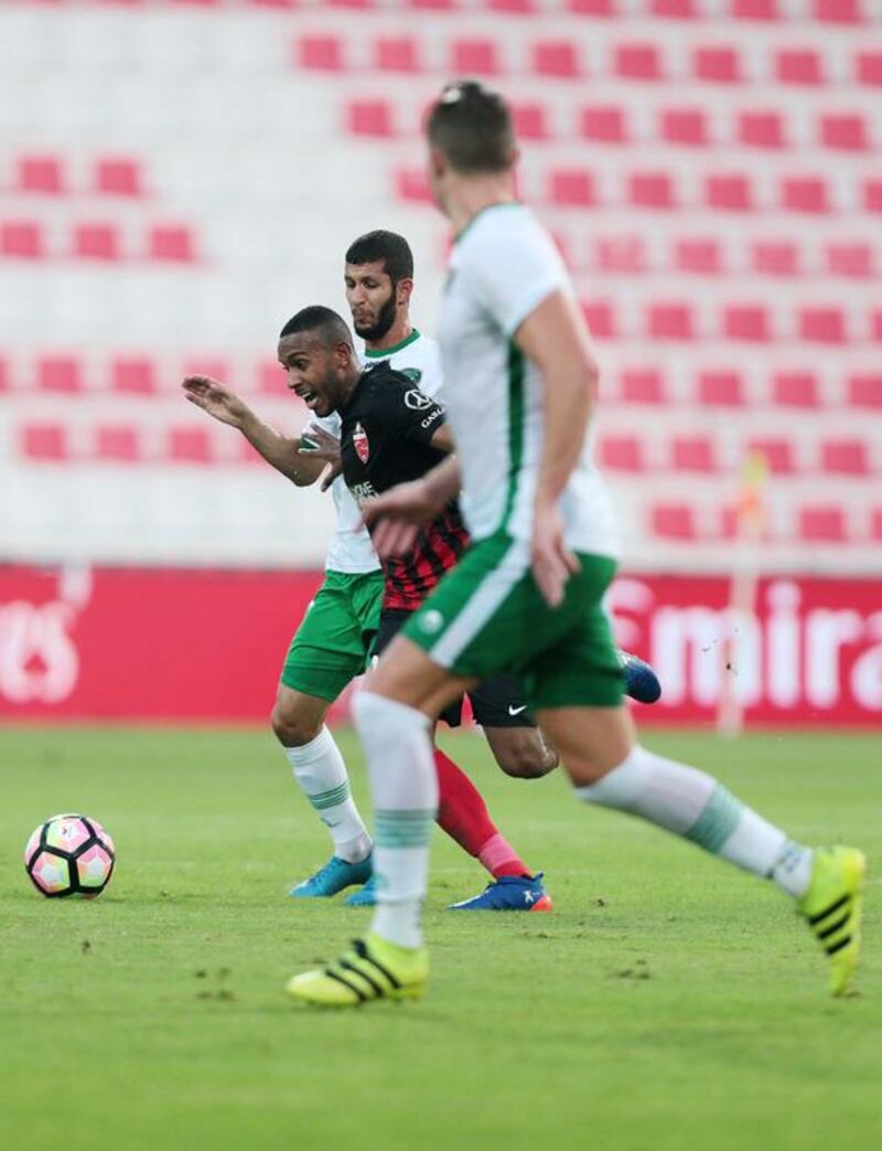 Al Ahli’s Saeed Ahmed, centre, battles for the ball against Emirates’ Alhusain Saleh, back, during their Arabian Gulf League match in Dubai on Saturday. Christopher Pike / The National