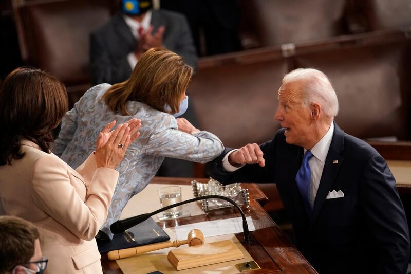 President Joe Biden elbow bumps House Speaker Nancy Pelosi of Calif., after speaking to a joint session of Congress Wednesday, April 28, 2021, in the House Chamber at the U.S. Capitol in Washington, as Vice President Kamala Harris watches. (AP Photo/Andrew Harnik, Pool)