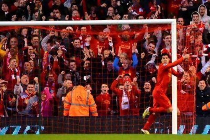 Liverpool's Uruguayan striker Luis Suarez celebrates after scoring his second goal during the English Premier League football match between Liverpool and Wigan Athletic at Anfield in Liverpool, north-west England on November 17, 2012. Liverpool won the game 3-0. AFP PHOTO/PAUL ELLIS

RESTRICTED TO EDITORIAL USE. No use with unauthorized audio, video, data, fixture lists, club/league logos or ìliveî services. Online in-match use limited to 45 images, no video emulation. No use in betting, games or single club/league/player publications.
 *** Local Caption *** 916590-01-08.jpg