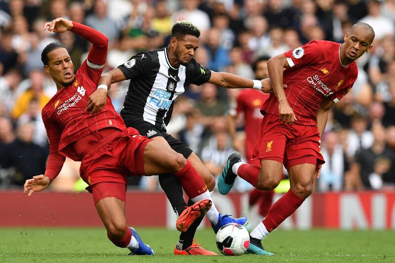 Liverpool's Dutch defender Virgil van Dijk tackleS Newcastle United's Brazilian striker Joelinton. AFP