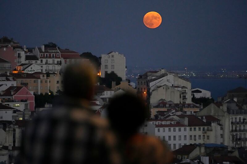 Watching a supermoon rise over Lisbon and the Tagus river. AP 