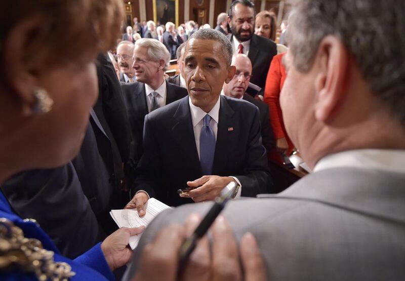President Obama signs autographs after the State of the Union address. Photo: Mandel Ngan / AFP 

