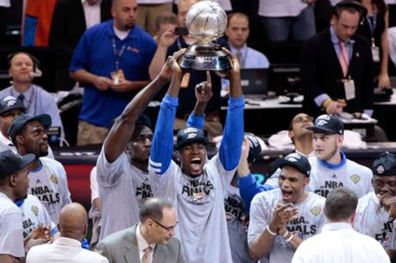 OKLAHOMA CITY, OK - JUNE 06: Serge Ibaka #9 of the Oklahoma City Thunder celebrates with the trophy after defeating the San Antonio Spurs to win the Western Conference Finals of the 2012 NBA Playoffs at Chesapeake Energy Arena on June 6, 2012 in Oklahoma City, Oklahoma. NOTE TO USER: User expressly acknowledges and agrees that, by downloading and or using this photograph, User is consenting to the terms and conditions of the Getty Images License Agreement.   Brett Deering/Getty Images/AFP== FOR NEWSPAPERS, INTERNET, TELCOS & TELEVISION USE ONLY ==

