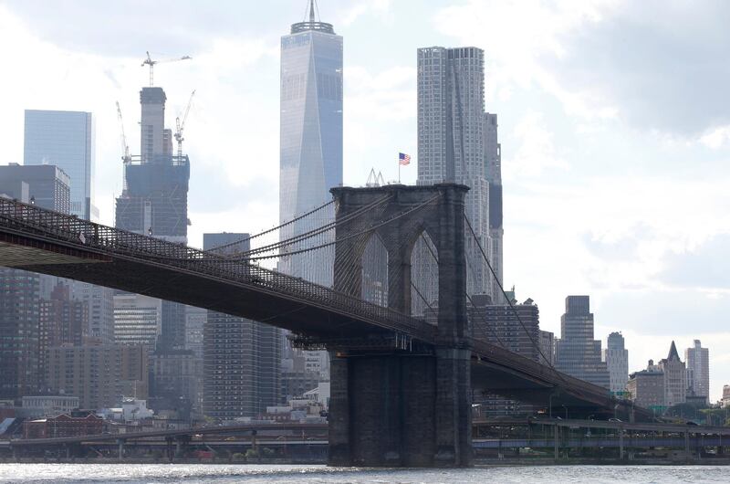 FILE - In this June 30, 2016 file photo, the Brooklyn Bridge spans the East River from Brooklyn into Manhattan, as seen from Brooklyn Bridge Park, in New York.  A federal judge has rejected an effort by the Department of Justice to strip a terrorist of U.S. citizenship. Pakistani-born Iyman Faris is a former Ohio truck driver and is serving the last years of a 20-year sentence imposed in 2003 for his guilty plea to plotting with al-Qaida to destroy New York's Brooklyn Bridge. The Department of Justice argues Faris entered the U.S. using someone else's passport, but his Chicago lawyer says his plea agreement never included the possibility of deportation.(AP Photo/Kathy Willens, File)