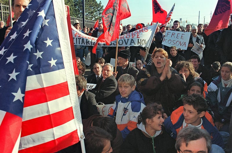 Hundreds of ethnic Albanians from the Serbian province of Kosovo protest against the inclusion of Serbia and its president Slobodan Milosevic in the peace talks between Bosnia, Croatia and Serbia, at the gate near the site of the talks 19 November 1995 at Wright Patterson Air Force Base near Dayton, Ohio. (Photo by PAUL J. RICHARDS / AFP)