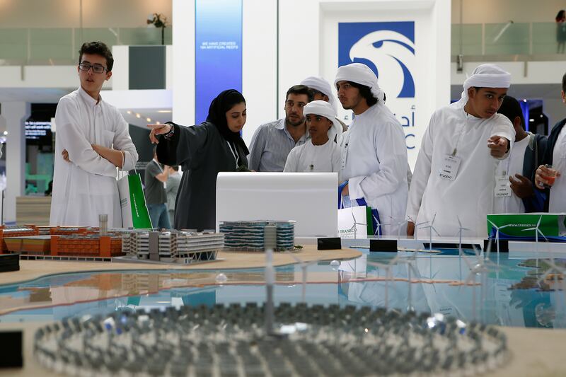 ABU DHABI, UNITED ARAB EMIRATES -17January 2017 - School children looks at a model of Solar panels displayed at Masdar stall at the World Future Energy Summit 2017, at the Abu Dhabi Exhibition Center. Ravindranath K / The NationalID: 62760 (to go with LeAnne Graves, Dania Al Saadi and Tony McAuley story for Business) *** Local Caption ***  RK1701-WFES09.jpg