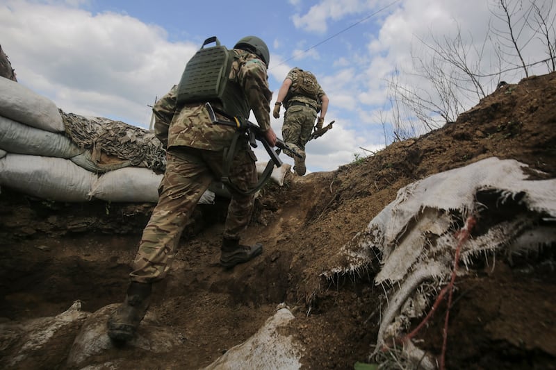 Ukrainian servicemen on patrol in Luhanske village.   EPA