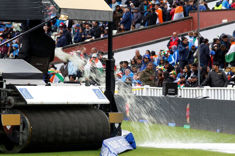 A ground staff pours out excess water off the field as rain continues to delay the start of ICC Champions Trophy final cricket match between England and India at Edgbaston cricket ground in Birmingham, England, Sunday, June 23, 2013. (AP Photo/Sang Tan)  *** Local Caption ***  Britain Cricket ICC Trophy Final England India.JPEG-03278.jpg