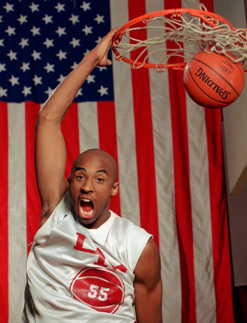 In this 1996 photo Kobe Bryant dunks the ball at his high school gym during a practice. Bryant, a five-time NBA champion and a two-time Olympic gold medalist, died in a helicopter crash in California on Sunday, January 26, 2020. AP Photo/Rusty Kennedy, File