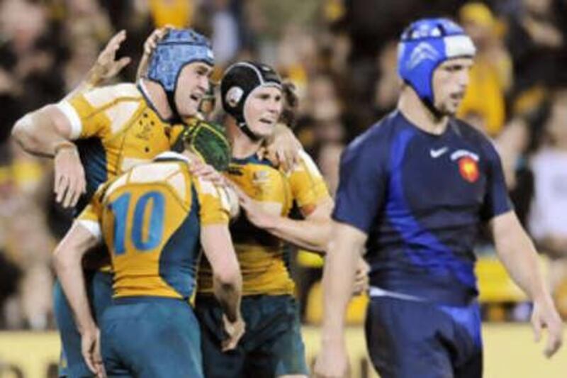 Australia's No10 Matt Giteau is congratulated by teammates after an instrumental display in beating France 40-10.