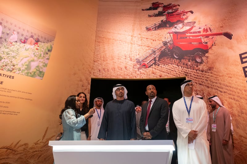 President Sheikh Mohamed and Mr Abiy tour the Ethiopian Pavilion at Cop28 alongside Sheikh Mansour bin Zayed, Vice President, Deputy Prime Minister and Chairman of the Presidential Court. Photo: UAE Presidential Court 