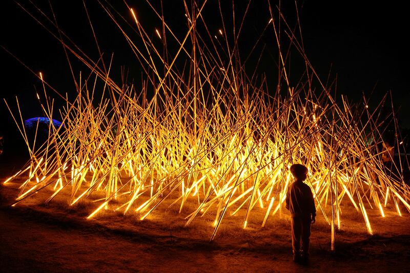 A child stands in front of a light sculpture at the Stavros Niarchos Foundation Cultural Centre during Christmas festivities, in Athens, Greece. Reuters