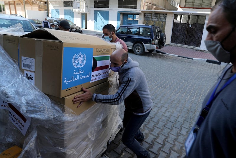 A worker unloads boxes containing ventilators delivered by the World Health Organization (WHO) and donated by Kuwait, in Gaza City. REUTERS