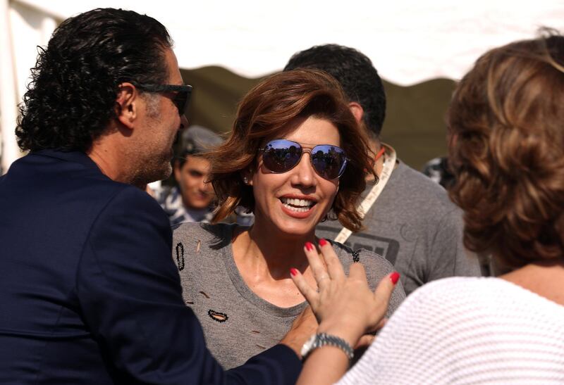 Lebanese singer Ragheb Alameh (L) welcomes Lebanese TV host Paula Yacoubian (C) during a karting race organised by Lebanese celebrities to mark the beginning of the Beirut Cultural Festival at Beirut's water front on May 20, 2016. / AFP PHOTO / PATRICK BAZ / “The erroneous mention[s] appearing in the metadata of this photo by PATRICK BAZ has been modified in AFP systems in the following manner: [---] instead of [---]. Please immediately remove the erroneous mention[s] from all your online services and delete it (them) from your servers. If you have been authorized by AFP to distribute it (them) to third parties, please ensure that the same actions are carried out by them. Failure to promptly comply with these instructions will entail liability on your part for any continued or post notification usage. Therefore we thank you very much for all your attention and prompt action. We are sorry for the inconvenience this notification may cause and remain at your disposal for any further information you may require.”
