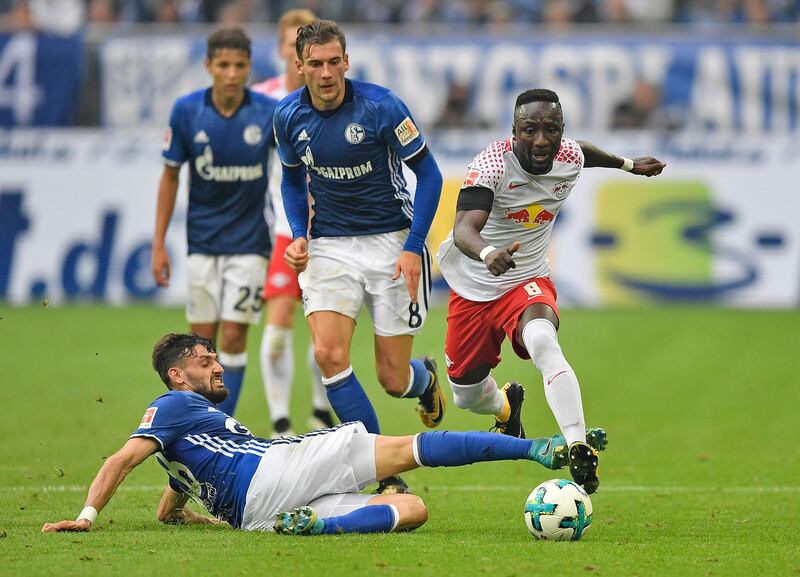 FILE - In this Aug. 19, 2017 file photo Leipzig's Naby Keita, right, and Schalke's Daniel Caligiuri, left, vie for the ball during the German Bundesliga soccer match between FC Schalke 04 and RB Leipzig at the Arena in Gelsenkirchen, Germany. Liverpool has reached an agreement to sign Naby Keita from German club Leipzig, with the Guinea midfielder moving to Anfield at the end of this season. (AP Photo/Martin Meissner)