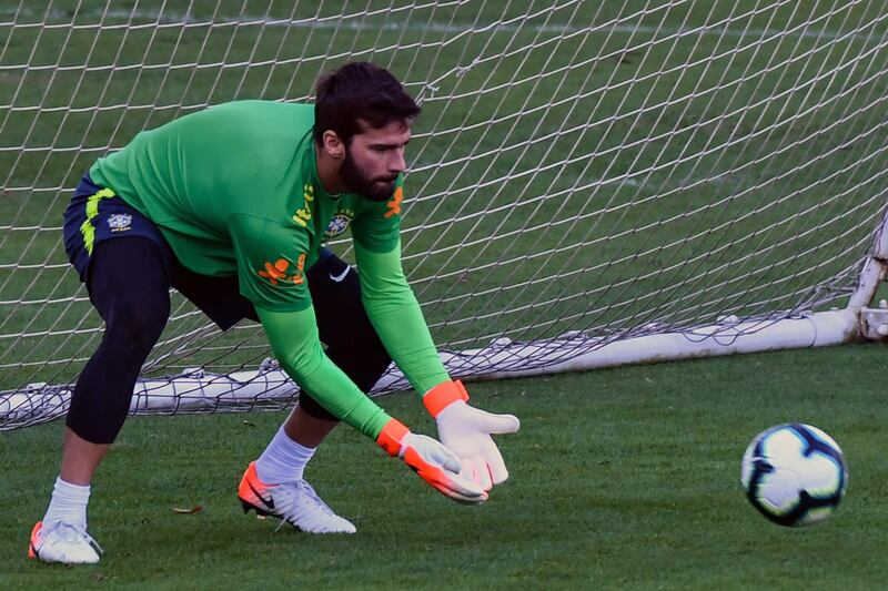 Brazil goalkeeper Alisson goes through his goalkeeping drills with the coaching staff. AFP