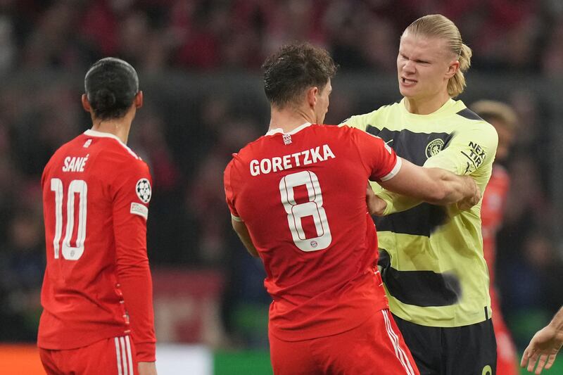 Manchester City's Erling Haaland scuffles with Bayern's Leon Goretzka. AP 