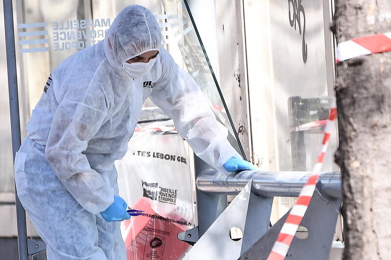 A French forensic police officer searches the site following a car crash on August 21, 2017, in the southern Mediterranean city of Marseille.  Boris Horvat / AFP