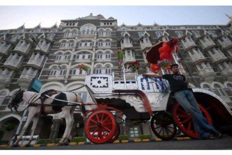 A carriage owner waits for customers outside the Taj Mahal Palace hotel in Mumbai.