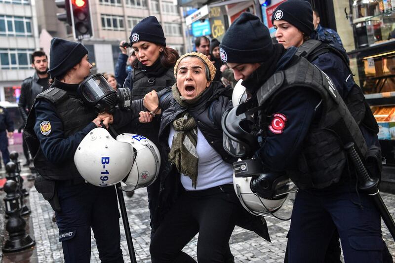A woman reacts as Turkish anti-riot police officers arrest her during a demonstration called by Halklarin Demokratik Partisi (Peoples' Democratic Party - HDP) members to protest against Turkey's "Olive Branch" operation in Syria on January 21, 2018 at the Kadikoy district, in Istanbul. - Turkey launched operation "Olive Branch" on January 20, 2018 seeking to oust from the Afrin region of northern Syria the Peoples' Protection Units (YPG) which Ankara considers a terror group. Operation "Olive Branch" is Turkey's second major incursion into Syria during the seven-year civil war. (Photo by OZAN KOSE / AFP)