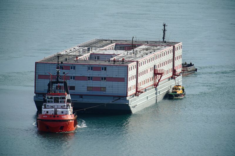 Tug boat Mercia pulls the Bibby Stockholm accommodation barge into Portland in Dorset. PA
