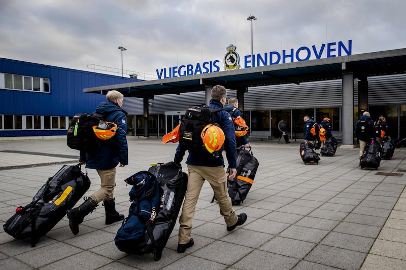 Members of the Dutch search and rescue team USAR arrive at Eindhoven Air Base to board a cargo plane. AFP