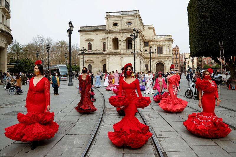 Women wearing flamenco dresses take part in a protest in Seville, Spain, against the crisis in the flamenco fashion sector caused by the coronavirus pandemic. Reuters