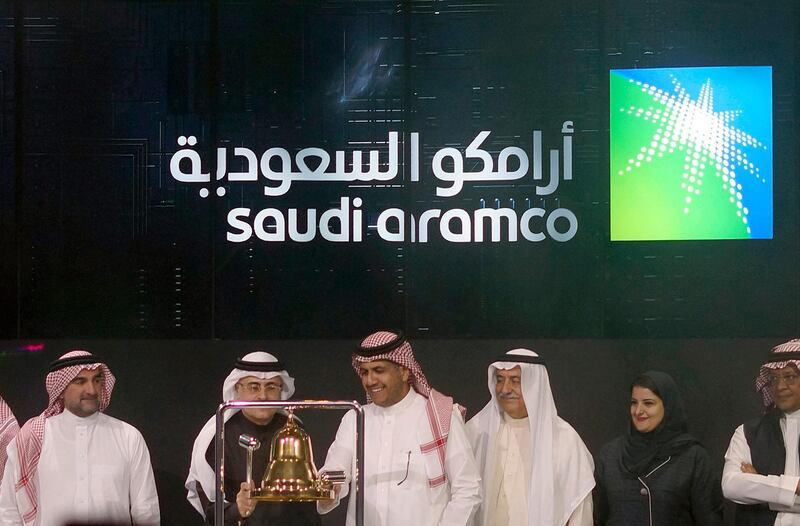 FILE - In Dec. 11, 2019, file photo Saudi Arabia's state-owned oil company Armco and stock market officials celebrate during the official ceremony marking the debut of Aramco's initial public offering (IPO) on the Riyadh's stock market, in Riyadh, Saudi Arabia. Saudi Aramco became the world's most valuable public company this year with a highly anticipated stock offering in December. (AP Photo/Amr Nabil, File)