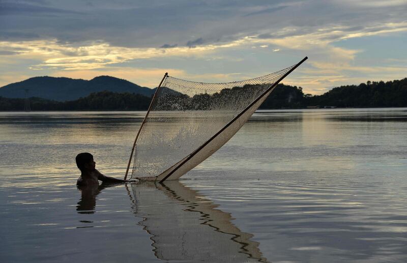 A man fishes in the Brahmaputra River in Guwahati.  AFP