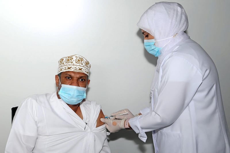 An Omani man receives a dose of the Pfizer/BioNTech Covid-19 vaccine in Oman's capital Muscat. AFP