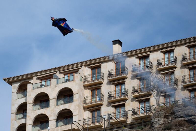 Base-jumper Dani Roman wearing a wingsuit crosses the main arc of the New Bridge in Ronda, Spain. AFP

