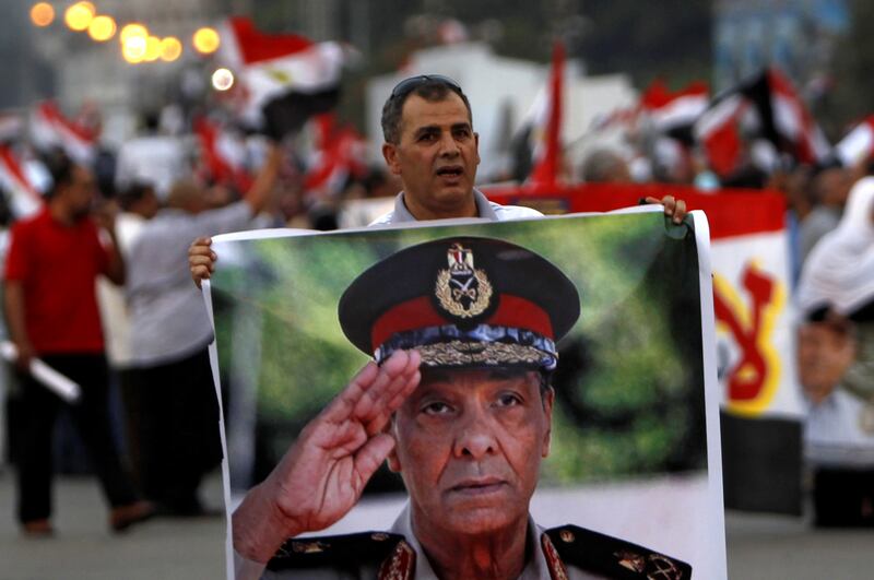 A supporter of presidential candidate Ahmed Shafik holds a poster of Mohammed Hussein Tantawi at a Cairo rally in 2012. Reuters