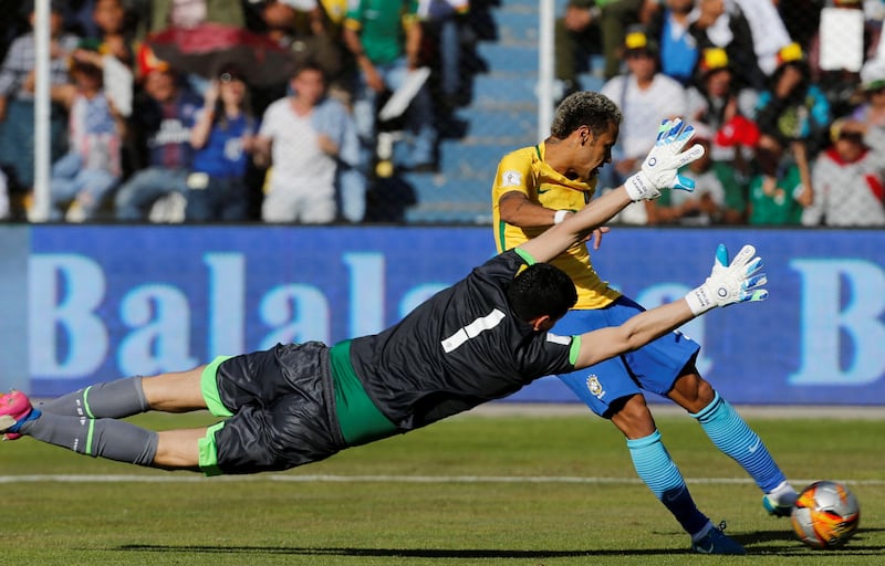 Bolivia goalkeeper Carlos Lampe at full stretch to block Neymar's effort on goal. David Mercado / Reuters