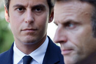 (FILES) France's President Emmanuel Macron (R) stands next to French Education and Youth Minister Gabriel Attal (L) at the 'lycée professionnel de l'Argensol' or Argensol vocational school during his visit of the school in Orange, Southeastern France on September 1, 2023.  French President Emmanuel Macron on January 9, 2024, named education minister Gabriel Attal as French Prime Minister in a bid to give new momentum to his presidency, with the 34-year-old becoming France's youngest and first openly gay head of government, a source close to the presidency told AFP.  (Photo by Ludovic MARIN  /  POOL  /  AFP)