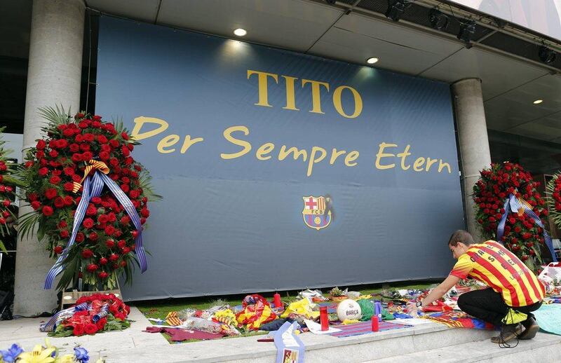Barcelona supporters leave mementos at a memorial to Tito Vilanova at the Camp Nou on Saturday. Former Barcelona coach Vilanova died following a battle with cancer that forced him to stand down at the end of last season, the club announced on Friday. The banner reads "Tito forever eternal" and the shirt "Thanks Tito, always eternal". Albert Gea / Reuters / April 26, 2014 