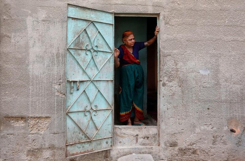 A woman stands at her door in Karachi, Pakistan. Akhtar Soomro / Reuters