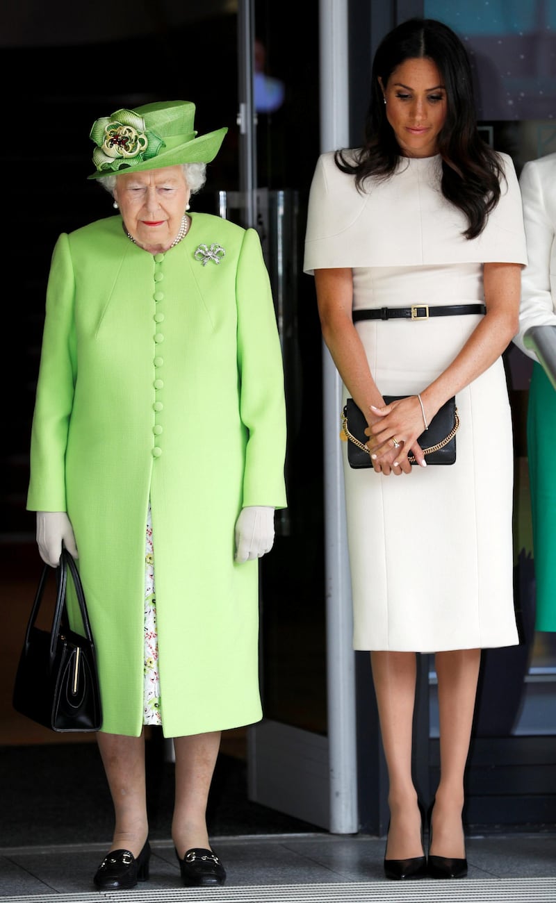 CHESTER, ENGLAND - JUNE 14:  Queen Elizabeth II and Meghan, Duchess of Sussex take a moment of silence for the victums of last year's Grenfell Tower fire as they arrive for their visit to the Storyhouse on June 14, 2018 in Chester, England. Meghan Markle married Prince Harry last month to become The Duchess of Sussex and this is her first engagement with the Queen. During the visit the pair will open a road bridge in Widnes and visit The Storyhouse and Town Hall in Chester.  (Photo by Phil Noble - WPA Pool/Getty Images)