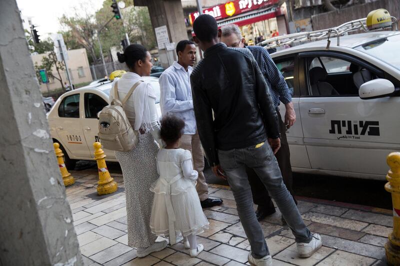 A family from Eritrea negotiates the price with an Israeli taxi driver in south Tel Aviv on March 19,2018.(Photo by Heidi Levine for The National).