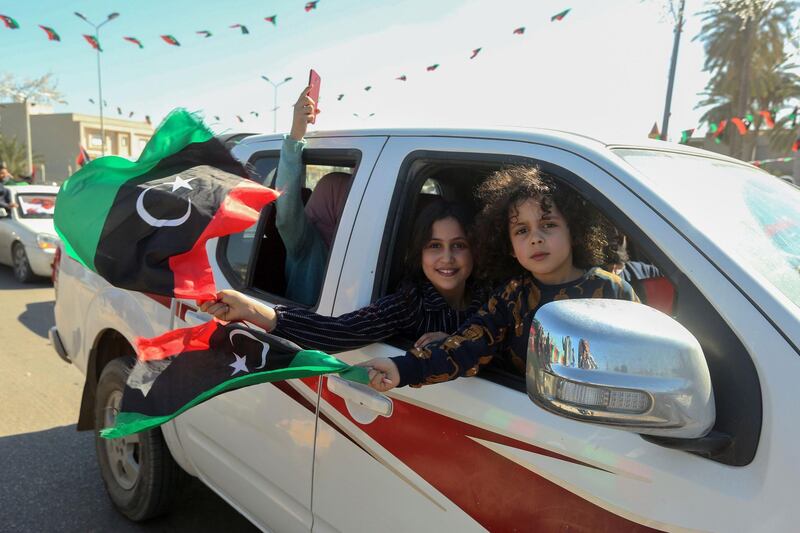 Libyans celebrate in Tripoli's Martyrs Square ahead of the upcoming ninth anniversary of the revolution which toppled Muammar Gaddafi. AFP