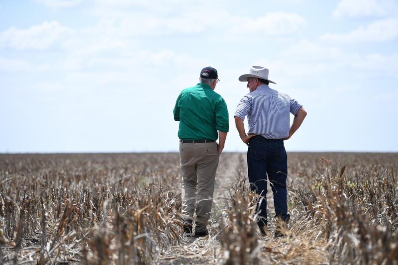 Australian Prime Minister Scott Morrison, left, converses with farmer David Gooding on his drought-affected property near Dalby, Queensland. EPA