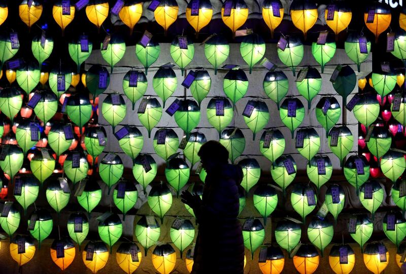 A woman prays in front of lanterns to celebrate the New Year at Jogyesa Buddhist temple in Seoul, South Korea. Ahn Young-joon / AP Photo