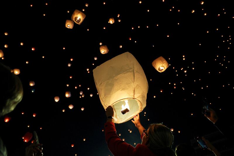 A person releases a sky lantern during Christmas festivities, in Athens. Reuters
