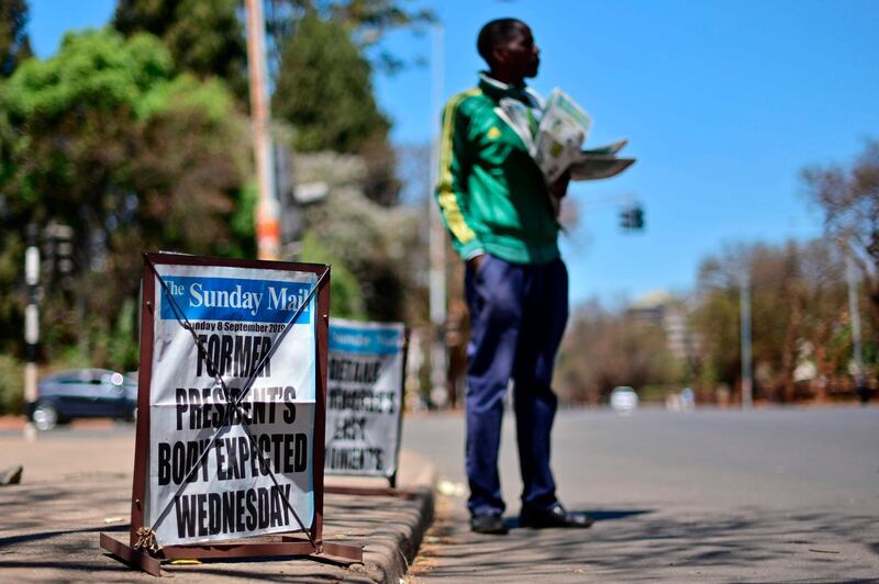A street vendor sells local newspapers in the streets of Harare carrying news of the arrival of the body of late former president Robert Mugabe on September 8, 2019.  Mugabe, a guerilla leader who swept to power after Zimbabwe's independence from Britain and went on to rule for 37 years, died on September 6, aged 95. His health took a hit after he was ousted by the military in November 2017, ending his increasingly tyrannical rule. He had been travelling to Singapore for treatment since April. 
 / AFP / TONY KARUMBA
