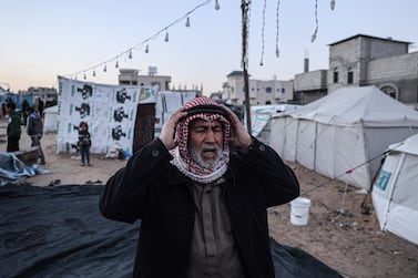 A displaced Palestinian man prays before breaking the fast on the first day of the Muslim holy fasting month of Ramadan, in Rafah in the southern Gaza Strip on March 11, 2024, amid ongoing battles between Israel and the militant group Hamas.  (Photo by SAID KHATIB  /  AFP)