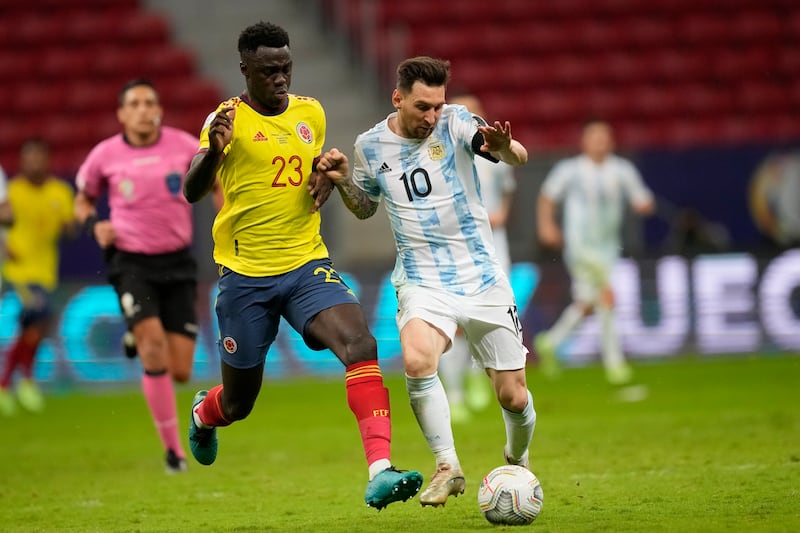 Lionel Messi, right, and Colombia's Davinson Sanchez battle for the ball.