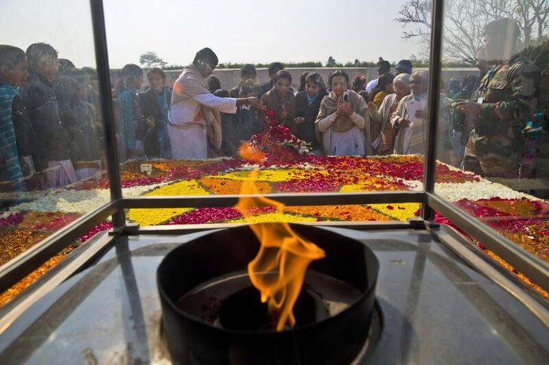 People pay their respect at Rajghat, a memorial to Mahatma Gandhi, on his death anniversary in New Delhi on January 30. The day when Gandhi was shot and killed in 1948 by Nathuram Godse, a Hindu extremist, is marked as Martyr's Day in the country. Saurabh Das / AP 