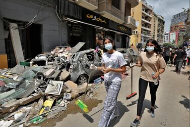 Volunteers clean up in the Al Gemayzeh area of Beirut after a explosion in the Lebanese capital's port caused destruction across half the city. EPA