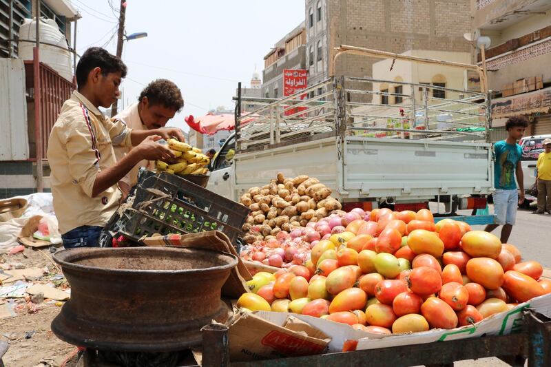 A fruit peddler sells produce from a cart along a market street in the Crater district in the centre of Yemen's Aden. AFP